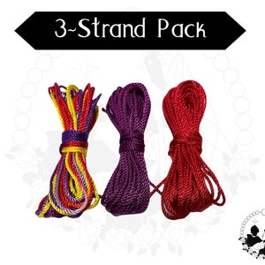 May include: Three bundles of rope in various colours. One bundle is a mix of yellow, red, purple, and white. The second is a deep purple, and the third is a bright red. The text "3-Strand Pack" is displayed in a black banner.