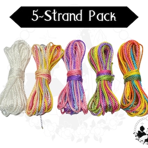May include: Five bundles of rope in various colours. One is white, and the others are multi-coloured with pink, yellow, purple, green, and orange hues. The text "5-Strand Pack" is displayed in a black banner above the ropes.