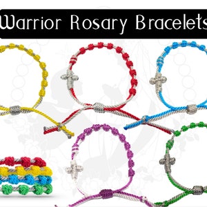 May include: A collection of Warrior Rosary Bracelets in various colors, including yellow, red, blue, green, and purple. Each bracelet features a cross charm and knotted beads. The text "Warrior Rosary Bracelets" is displayed at the top.