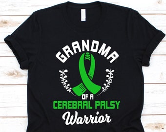 May include: Black t-shirt with the text "GRANDMA OF A CEREBRAL PALSY WARRIOR" in white and green. The design includes a green ribbon and a wreath. A crew neck tee.