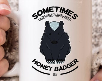 May include: White ceramic mug featuring a black and white illustration of a honey badger. The mug has the text "SOMETIMES I ASK MYSELF WHAT WOULD HONEY BADGER DO?" in black lettering.