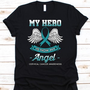 Koszulka My Hero Is Now My Angel, prezent na temat świadomości raka dla wojowniczki z rakiem szyjki macicy, t-shirt z wstążką na raka szyjki macicy