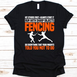 May include: Black t-shirt with the word "FENCING" in orange block letters. The shirt features white text that reads "HIT OTHERS FIRST - ALWAYS START IT, RUN WITH SHARP OBJECTS, DO EVERYTHING THAT YOUR PARENTS TOLD YOU NOT TO DO." Two white fencing figures are also displayed.
