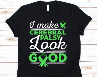 May include: Black t-shirt with the text "I make Cerebral Palsy Look Good" in white and green. The design includes green awareness ribbons. A casual tee for raising awareness.