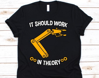 May include: Black t-shirt with the text "IT SHOULD WORK IN THEORY" above a yellow robotic arm graphic. Two yellow cogwheels are on either side of the words "IN THEORY". The shirt is made of a soft material.