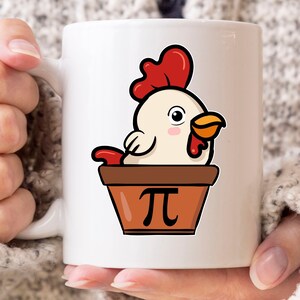 May include: White ceramic mug featuring a cartoon chicken with a red comb and orange beak, peeking out of a brown flower pot. The pot has a black Pi symbol on it. The mug is held by a person.