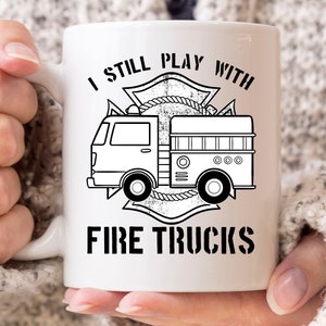 I Still Play With Fire Trucks Mug, Funny Firefighter Coffee Cup For Fireman In Fire Stations, Cool Firefighting Mug Gift For Men And Women