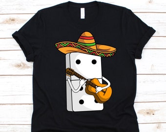 May include: Black t-shirt featuring a cartoon domino wearing a sombrero and playing a guitar. The domino is white with black dots. The sombrero is orange, green, and yellow. The guitar is brown and orange.