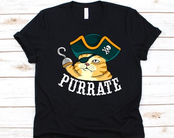 May include: Black t-shirt featuring a cartoon cat wearing a pirate hat and eye patch, holding a hook. The text "PURRATE" is printed in white below the cat. The cat is orange and white.