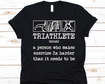 May include: Black t-shirt with white text and graphics. The text reads "TRIATHLETE (noun) a person who makes exercise 3x harder than it needs to be." The graphics depict swimming, cycling, and running.