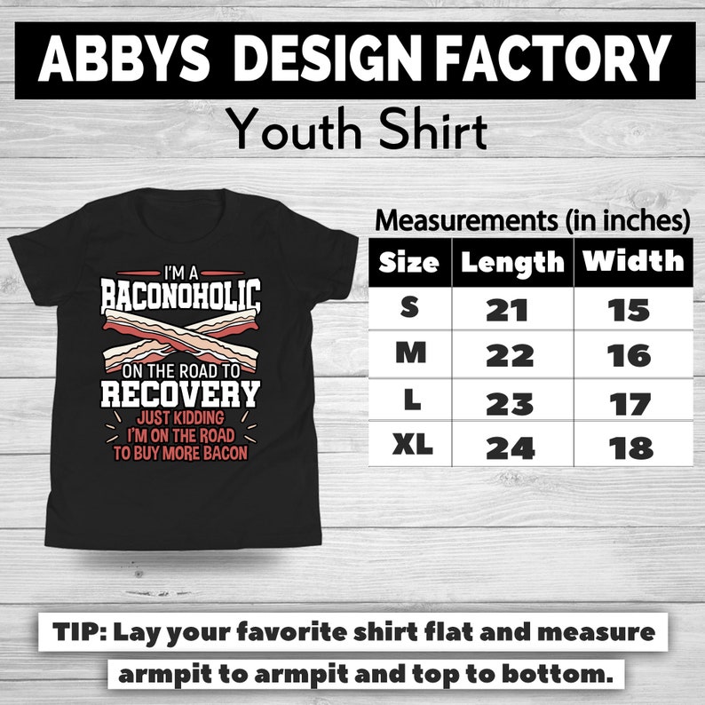 May include: Black youth shirt with the text "I'M A BACONOHOLIC ON THE ROAD TO RECOVERY JUST KIDDING I'M ON THE ROAD TO BUY MORE BACON." Measurements are provided in inches: S (21x15), M (22x16), L (23x17), XL (24x18).