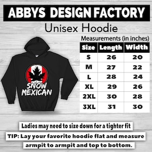 Pode incluir: Moletom unissex preto com capuz e um gr&aacute;fico "SNOW MEXICAN" com um design de folha de bordo canadense. A tabela de tamanhos mostra as medidas em polegadas. O texto "ABBYS DESIGN FACTORY" est&aacute; no topo.