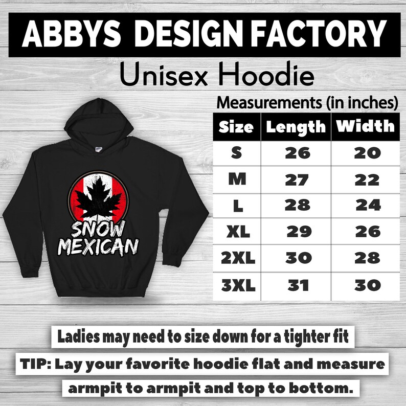 Pode incluir: Moletom unissex preto com capuz e um gr&aacute;fico "SNOW MEXICAN" com um design de folha de bordo canadense. A tabela de tamanhos mostra as medidas em polegadas. O texto "ABBYS DESIGN FACTORY" est&aacute; no topo.