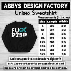 May include: Black unisex sweatshirt with the text "FUX PTSD" in white, and a teal ribbon graphic. The sweatshirt has a size chart with measurements in inches. The brand name "ABBYS DESIGN FACTORY" is at the top.