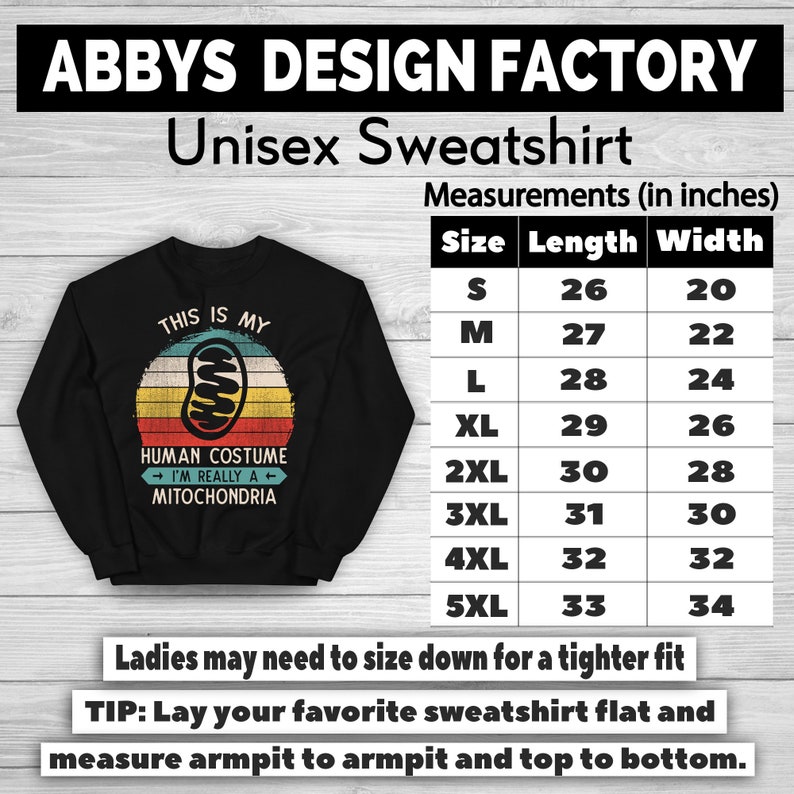 May include: Black unisex sweatshirt with a retro design. The graphic reads "THIS IS MY HUMAN COSTUME I'M REALLY A MITOCHONDRIA" with a mitochondria illustration. Measurements are provided in inches, with sizes ranging from S to 5XL.