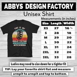 May include: Black unisex t-shirt with a retro design. The shirt features the text "THIS IS MY HUMAN COSTUME I'M REALLY A MITOCHONDRIA" in a circular design. Measurements are provided in inches, with lengths ranging from 27 to 33 inches and widths from 16 1/2 to 28 inches.