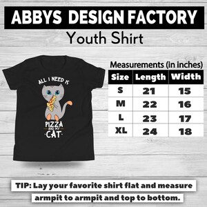 May include: Black youth shirt with a graphic of a gray cat holding pizza and the text "ALL I NEED IS PIZZA AND MY CAT." Measurements are provided in inches: S (21" length, 15" width), M (22" length, 16" width), L (23" length, 17" width), XL (24" length, 18" width).