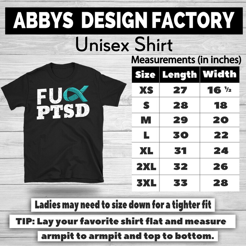 May include: Black unisex t-shirt with the text "FUX PTSD" in white, and a teal ribbon graphic. The shirt has a size chart with measurements in inches. The shirt is from Abbys Design Factory.
