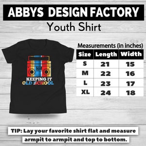 May include: Black youth shirt with a retro boombox graphic in red, yellow, and blue. The shirt has the text "KEEPING IT OLD SCHOOL". Measurements are provided in inches: S (21" length, 15" width), M (22" length, 16" width), L (23" length, 17" width), XL (24" length, 18" width).