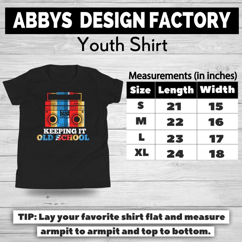 May include: Black youth shirt with a retro boombox graphic in red, yellow, and blue. The shirt has the text "KEEPING IT OLD SCHOOL". Measurements are provided in inches: S (21" length, 15" width), M (22" length, 16" width), L (23" length, 17" width), XL (24" length, 18" width).