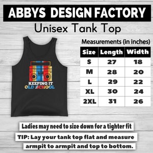 May include: Black unisex tank top with a retro boombox graphic in red, yellow, and blue. The text "KEEPING IT OLD SCHOOL" is below the boombox. Measurements are provided in inches, with sizes ranging from S to 2XL.