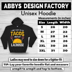 May include: Black unisex hoodie with the text "I JUST WANT TO EAT TACOS AND PLAY LACROSSE". The hoodie has a hood and a graphic of a taco and lacrosse sticks. Measurements are provided in inches (approx. 66 cm length, 51 cm width).