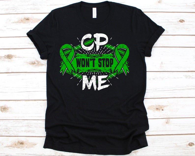 May include: Black t-shirt with a green and white graphic. The graphic includes the letters "CP" above the words "WON'T STOP ME", with green awareness ribbons on either side. The design has a distressed, vintage look.