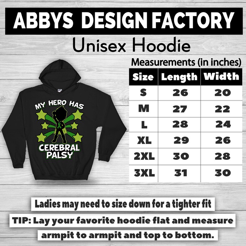 May include: Black unisex hoodie with the text "MY HERO HAS CEREBRAL PALSY" and a graphic of a superhero. The hoodie has a hood and a size chart with measurements in inches. The brand name "ABBYS DESIGN FACTORY" is at the top.