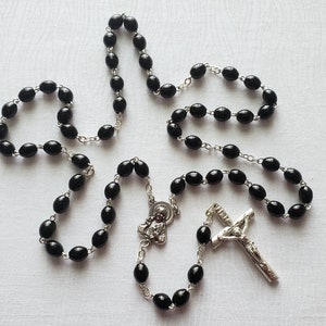 Black Plastic Catholic Rosary with Elongated Beads and a Sacred Heart Centerpiece Medal