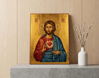 May include: A rectangular religious icon painting featuring a central figure with a beard, wearing a red robe and blue mantle, displaying a flaming heart on the chest. The background is gold with a halo and the Greek letters IC, XC, and N.