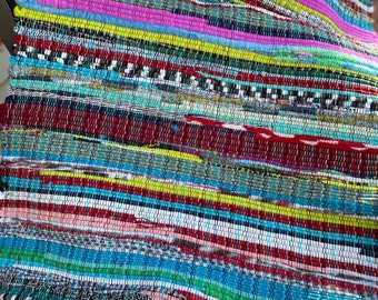 Rug “Bohemian Rugsody” 36” or 40” Hand Loomed Woven.  Boost your mood w/all the vibrant colors in this scrappy rag rug Machine washable!!