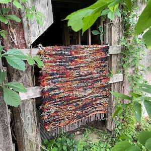 Handmade hand woven rug fuzzy Wool textured “Campfire” 34”x29” with orange yellow and red “fire”, deep midnight blue, cerulean, beige black