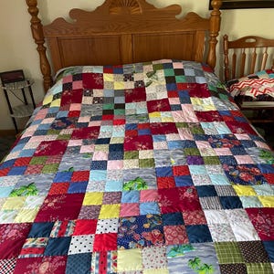 Gorgeous Scrappy handmade Quilt with lots of vintage pretty fabrics hand quilted & finished with triangle points around the quilt  92”x86”