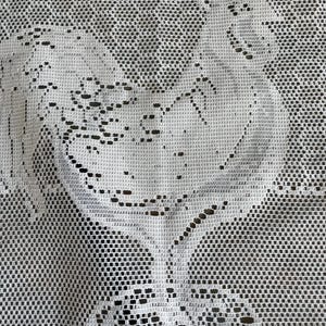 May include: White lace curtain with a delicate embroidered design of a rooster. The rooster is facing right and has a detailed comb and wattle.