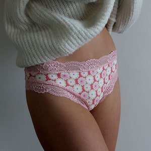 May include: Pink and white floral print underwear with a delicate lace trim.