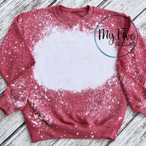 May include: A maroon crewneck sweatshirt with a bleached white center. The sweatshirt has a distressed, speckled design. The text "My Five Designs" is visible in a teal circle on the right side of the sweatshirt.