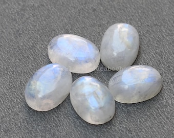 May include: Six oval-shaped moonstone cabochons in various sizes, with a milky white color and iridescent blue flashes.