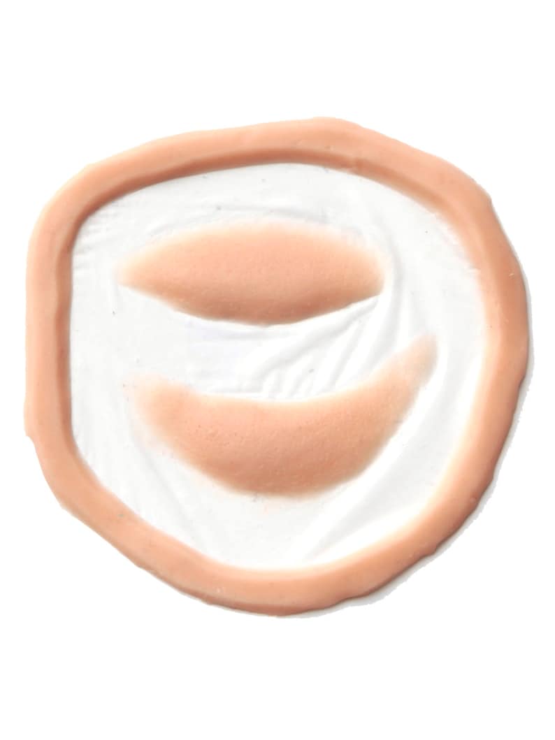 Puede incluir: Primer plano de un molde de silicona de color carne con dos impresiones ovaladas en relieve. El molde est&aacute; dise&ntilde;ado para crear heridas o cicatrices de aspecto realista.