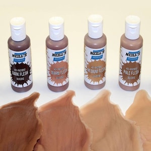 May include: Four bottles of silicone flesh tone paint for use in special effects makeup. The bottles are labeled "Dark Flesh", "Warm Flesh", "Medium Flesh", and "Pale Flesh".