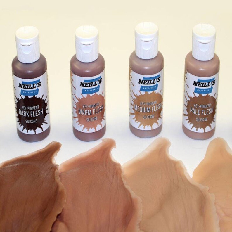 May include: Four bottles of silicone flesh tone paint for use in special effects makeup. The bottles are labelled "Dark Flesh", "Warm Flesh", "Medium Flesh", and "Pale Flesh".