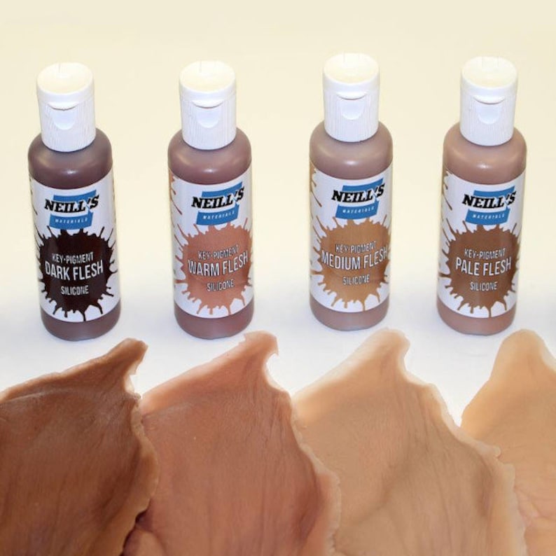 May include: Four bottles of silicone flesh tone paint. The bottles are labeled "Dark Flesh", "Warm Flesh", "Medium Flesh", and "Pale Flesh".