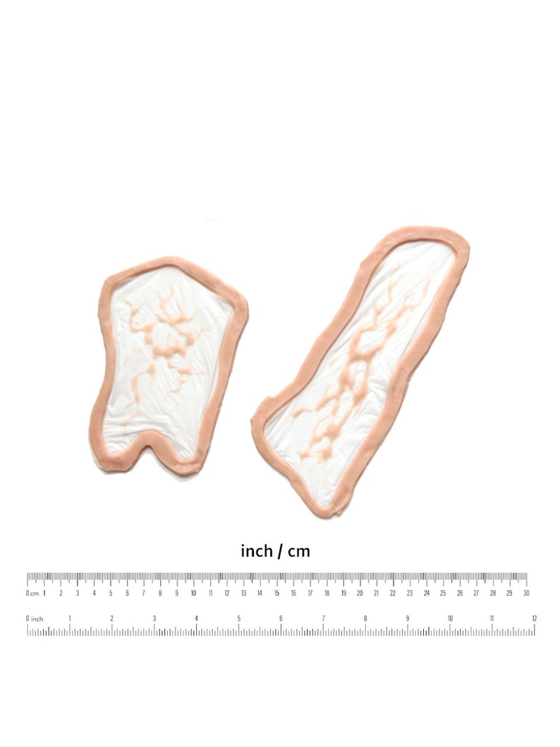 May include: Two silicone moulds for making resin crafts. The moulds are shaped like a long, thin rectangle and a short, wide rectangle. The moulds are made of a clear silicone material and have a light pink colour.