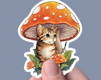 Smol Cat Under a Mushroom sticker, white backed vinyl, matte sticker, decal sticker for laptops, cars, hydroflask, toolbox, waterproof
