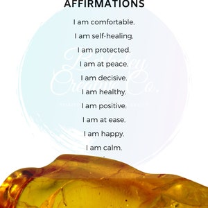 May include: A yellow amber stone against a white background with the text "Solar Plexus Chakra Affirmations" and a list of affirmations: "I am comfortable. I am self-healing. I am protected. I am at peace. I am decisive. I am healthy. I am positive. I am at ease. I am happy. I am calm."