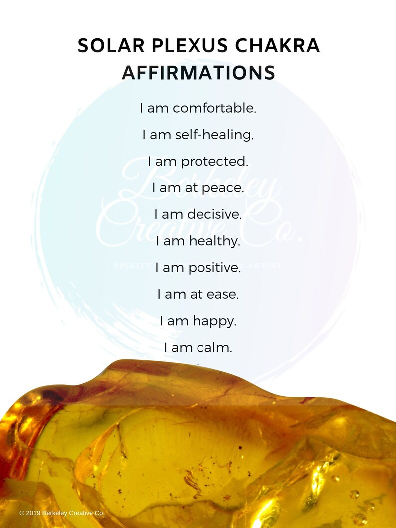 May include: A yellow amber stone against a white background with the text "Solar Plexus Chakra Affirmations" and a list of affirmations: "I am comfortable. I am self-healing. I am protected. I am at peace. I am decisive. I am healthy. I am positive. I am at ease. I am happy. I am calm."