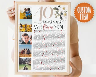 May include: A framed print with a white background and floral accents. The print features 40 reasons to love someone, with a collage of photos in the background. The text reads "40 reasons we love you".