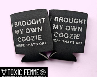 May include: Two black foam can coolers with the text "I brought my own coozie (hope that's ok)" printed in silver on them.