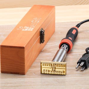 200W soldering iron includes a wooden storage box and customizable logo stamps.