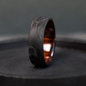 Carbon Fiber and Ironwood Ring: Nature and technology unite in elegance.