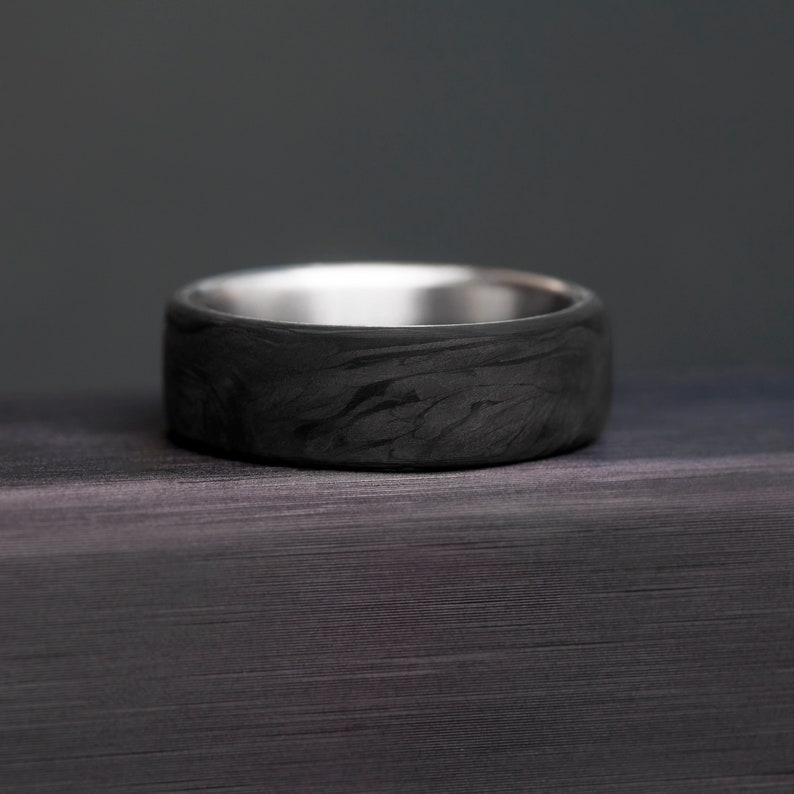 Forged Carbon Fiber Band: Contemporary elegance in a titanium ring.